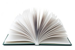 An open book with fanned pages, isolated on a white background. A detailed clipping path is included.